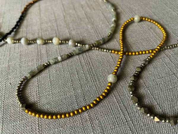 closeup of gemstone bead necklace comprising labradorite, raw pyrite, dark bronze and gold hematite