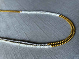 side view of gemstone bead necklace comprising white moonstone, silver and gold hematite