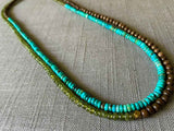 top view of gemstone bead necklace comprising turquoise, green sapphire and exotic wood