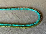 side view of gemstone bead necklace comprising turquoise, green sapphire and exotic wood