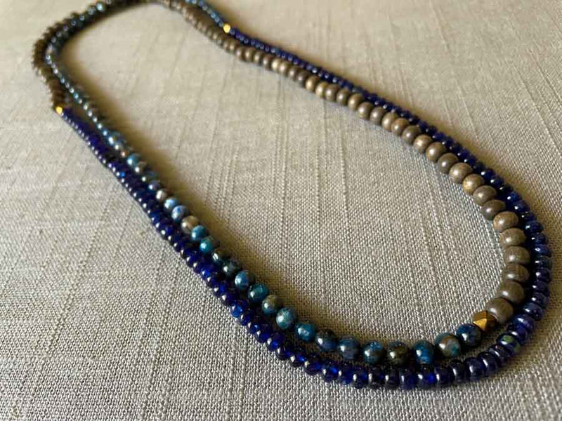 top view of gemstone bead necklace comprising blue kyanite, blue sapphire and exotic wood