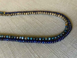 side view of gemstone bead necklace comprising blue kyanite, blue sapphire and exotic wood