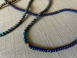 closeup of gemstone bead necklace comprising blue kyanite, blue sapphire and exotic wood