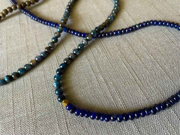 closeup of gemstone bead necklace comprising blue kyanite, blue sapphire and exotic wood