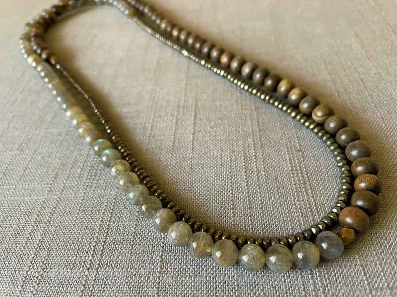 top view of gemstone bead necklace comprising labradorite, dark grey pyrite and exotic wood