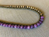 side view of gemstone bead necklace comprising purple lepidolite, dark grey pyrite and exotic wood