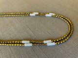 side view of gemstone bead necklace comprising white quartz, light gold hematite and golden pyrite