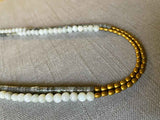 side view of gemstone bead necklace comprising labradorite, off-white siberian moonstone and gold hematite