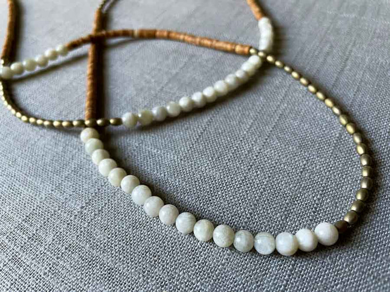 closeup of gemstone bead necklace comprising golden feldspar, off-white siberian moonstone and light gold hematite