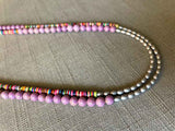 side view of gemstone bead necklace comprising multicolored vinyl discs, light purple phosphosiderite and silver hematite