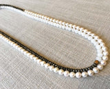 top view of gemstone bead necklace comprising white pearl, white moonstone and pyrite