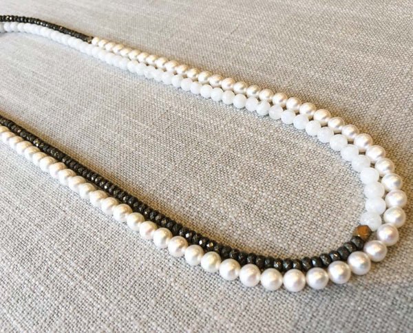 top view of gemstone bead necklace comprising white pearl, white moonstone and pyrite