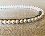 side view of gemstone bead necklace comprising white pearl, white moonstone and pyrite