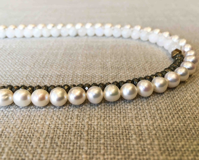 side view of gemstone bead necklace comprising white pearl, white moonstone and pyrite