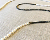 closeup of gemstone bead necklace comprising white pearl, white moonstone and pyrite.