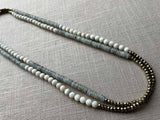 top view of gemstone bead necklace comprising white moonstone, grey moonstone and golden pyrite