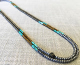 top view of gemstone bead necklace comprising turquoise, gold hematite and silver hematite