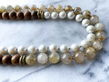 side view of gemstone bead necklace comprising white pearl, neutral rutilated quartz and exotic wood with antler clasp