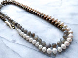 top view of gemstone bead necklace comprising white pearl, grey mink moonstone and exotic wood with antler clasp