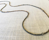 closeup of gemstone bead necklace comprising grey moonstone, bronze and dark grey pyrite