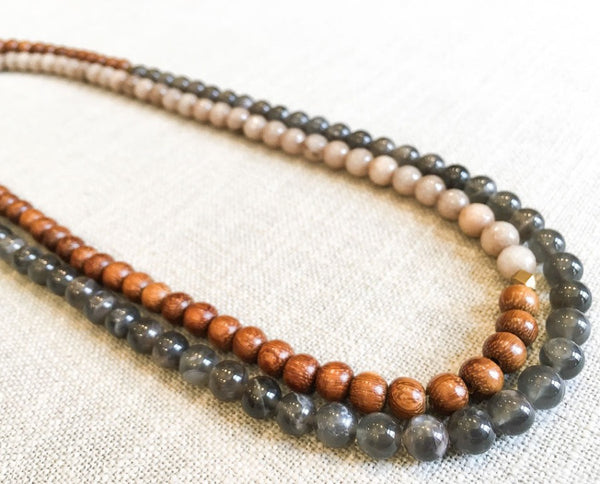  top view of gemstone bead necklace comprising grey moonstone, taupe quartz and exotic wood