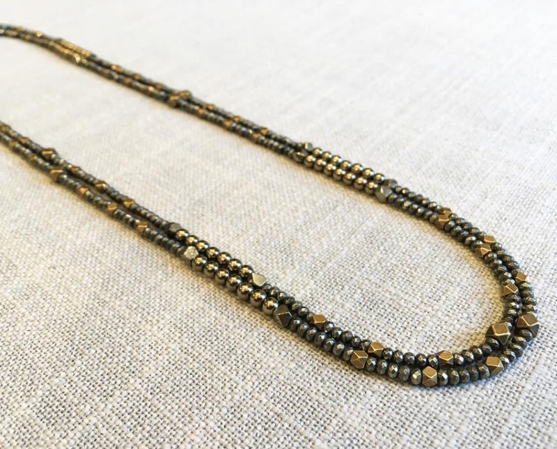 top view of gemstone bead necklace comprising dark grey pyrite and bronze