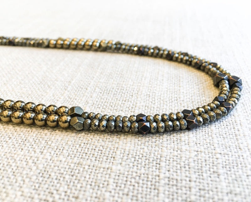 side view  of gemstone bead necklace comprising metallics