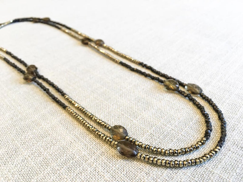 top view of gemstone bead necklace comprising dark bronze, golden pyrite and smoky quartz