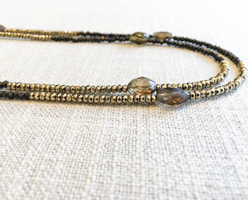 side view  of gemstone bead necklace comprising metallics and smoky quartz