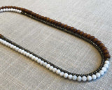 top view of gemstone bead necklace comprising white moonstone, exotic wood and dark grey pyrite