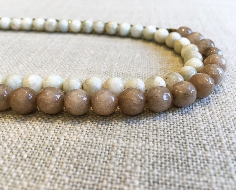 side view of gemstone bead necklace comprising taupe quartz, white siberian moonstone and metallics