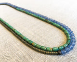 top view of gemstone bead necklace comprising blue apatite, turquoise and dark grey pyrite