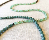 closeup of gemstone bead necklace comprising blue chrysoprase, bronze hematite and sea foam moss agate