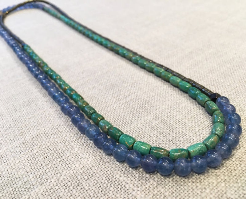 top view of gemstone bead necklace comprising blue kyanite, teal iolite and pyrite