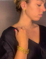 model wearing organic-shaped gold bracelet