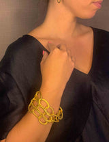 model wearing organic-shaped gold bracelet