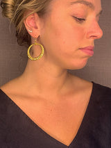 model wearing organic-shaped gold earrings