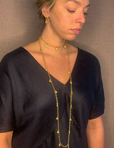 model wearing organic-shaped gold earrings