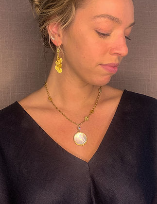 model wearing organic-shaped gold earrings