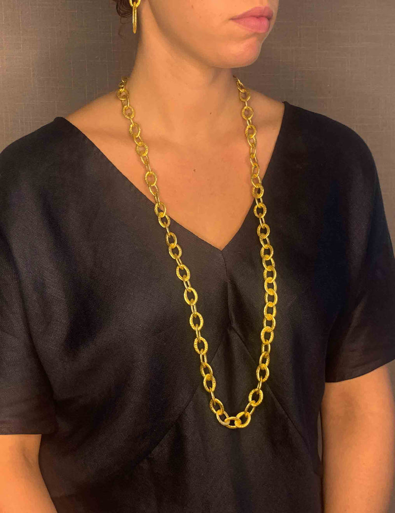 model wearing organic-shaped gold necklace