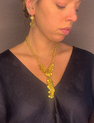 model wearing organic-shaped gold necklace