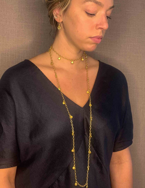 model wearing organic-shaped gold necklace