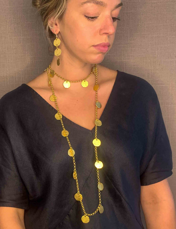 model wearing organic-shaped gold necklace