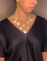 model wearing organic-shaped gold necklace