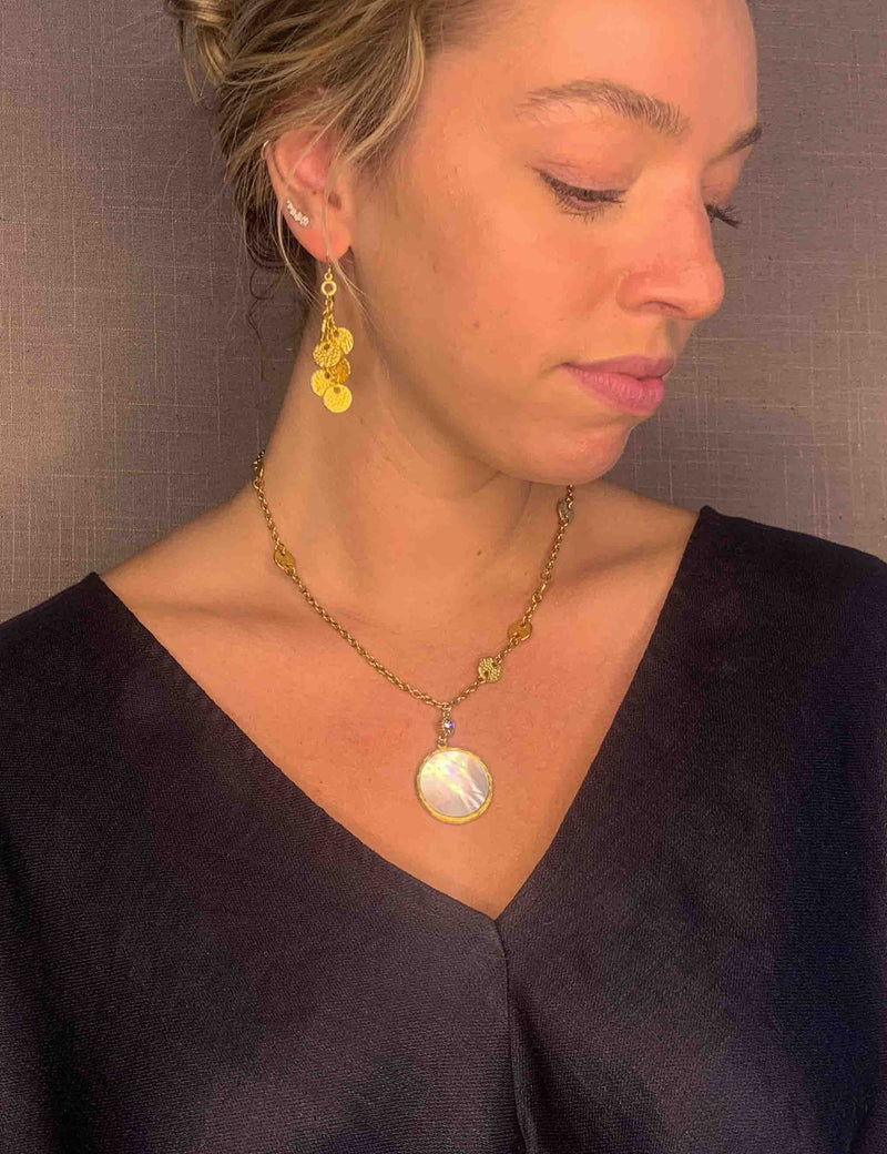 model wearing organic-shaped gold necklace