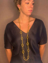 model wearing organic-shaped gold necklace