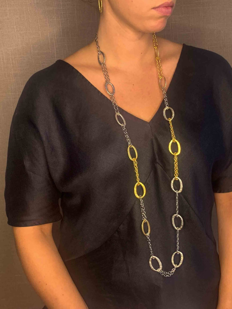 model wearing organic-shaped gold and silver necklace