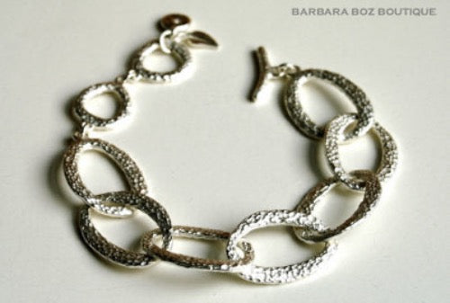 closeup of organic-shaped silver bracelet