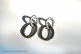 top view of organic-shaped silver earrings