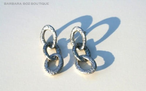 top view of organic-shaped silver earrings